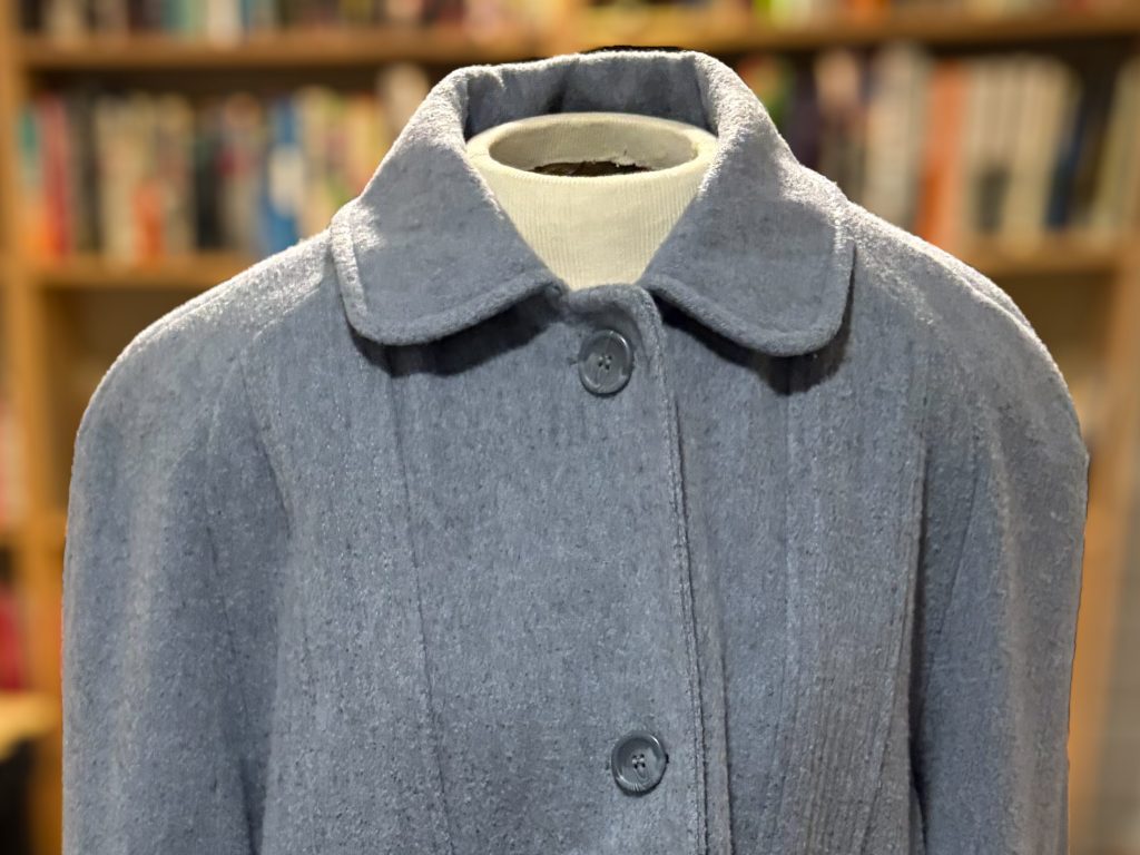 A light bluish-grey wool coat. 