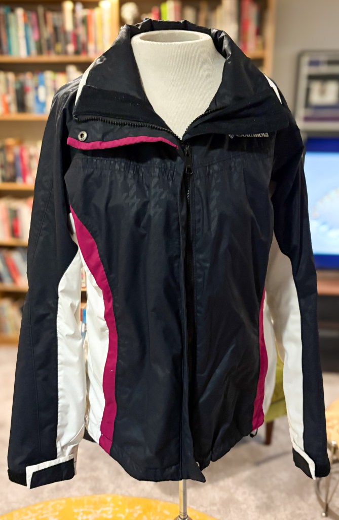 Black, white and pink nylon windbreaker. 