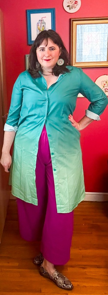 This funky outfit pairs an ombre green shirt dress with purple trousers.