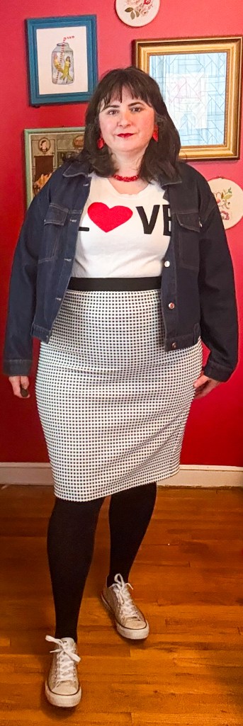 A chic outfit with a black-white-and-red "Love" sweater and black and white pencil skirt. 