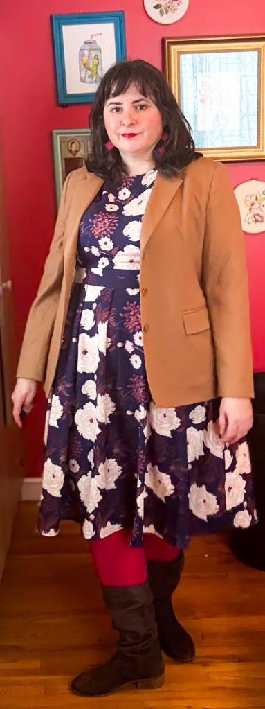 A neutral outfit featuring a navy floral dress, brown blazer and hot pink tights. 