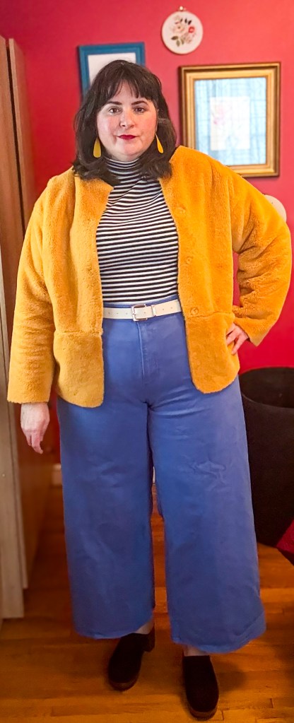 This cute outfit features sky-blue jeans, a black-and-white striped shirt and a yellow faux-fur jacket. 